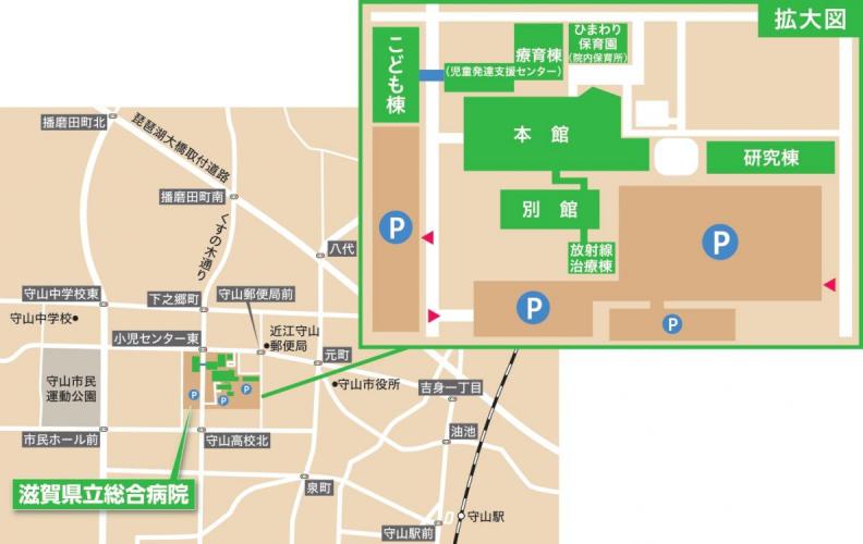 バスロータリー前の建物が本館、本館の南側に別館と放射線治療棟、東側に研究棟、北側に療育棟、道路を挟んで西側にこども棟がある。